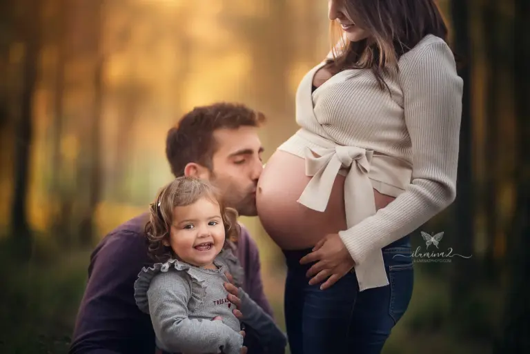 Niño abrazando la barriga de su mamá en una sesión de embarazo en Barcelona