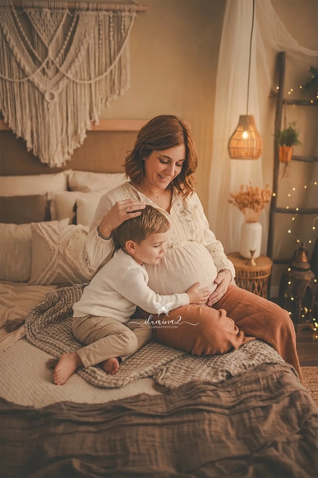 Niño abrazando la barriga de su madre embarazada en una sesión de fotos en estudio